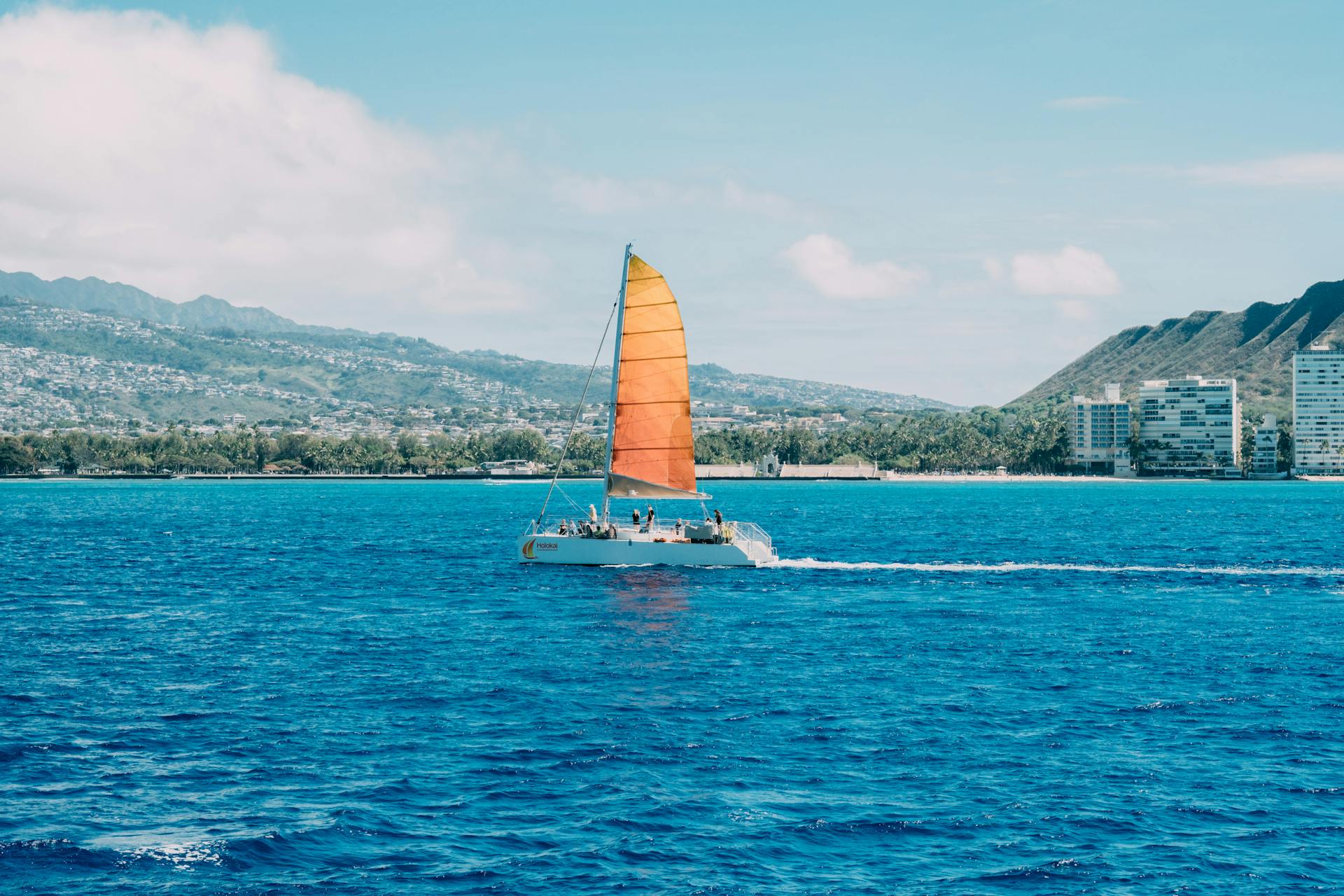 Sailing Catamaran with Orange Sail