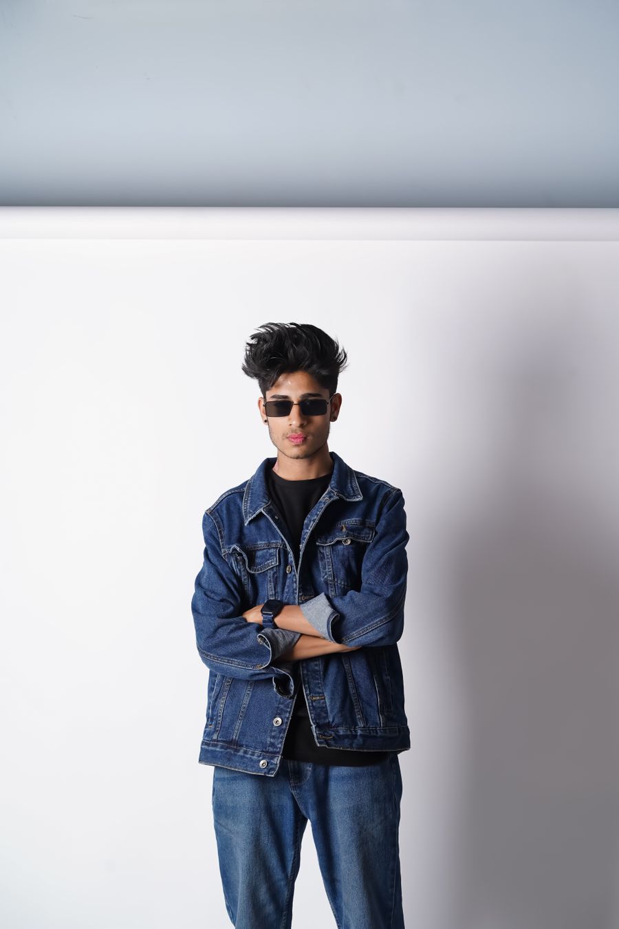 Studio product photo of a model in a classic denim jacket, white background