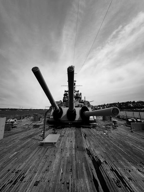 Black and white photo of a battleship on a pier