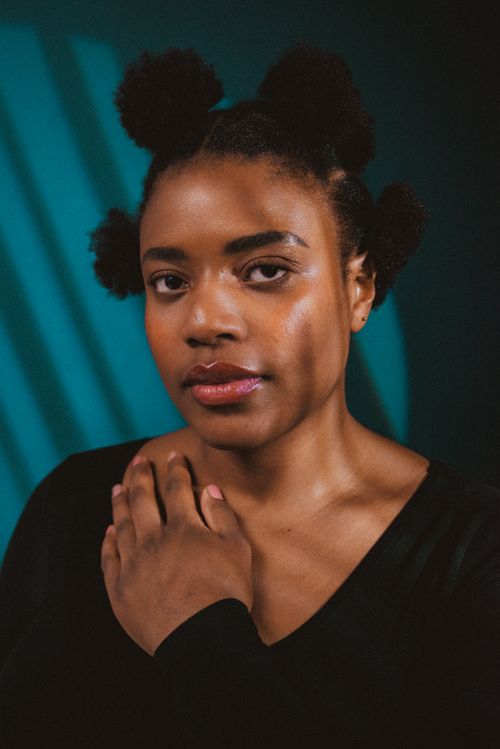 Free Elegant portrait of a black woman in studio setting showcasing natural hairstyle and poise. Stock Photo
