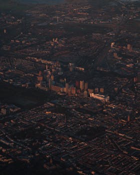 Stunning aerial view of Amsterdam showcasing urban landscape at twilight with city architecture.