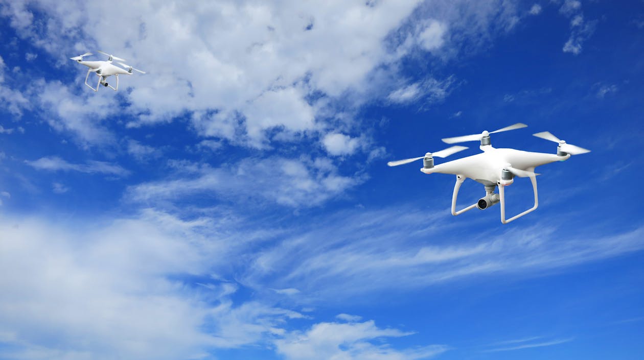 Free 2 Quadcopter Under Blue Sky and White Clouds Stock Photo