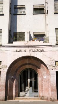 Front view of Edificio Villarcayo entrance, showcasing classic architecture under bright daylight.