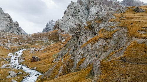 Mountains around Stream in Valley