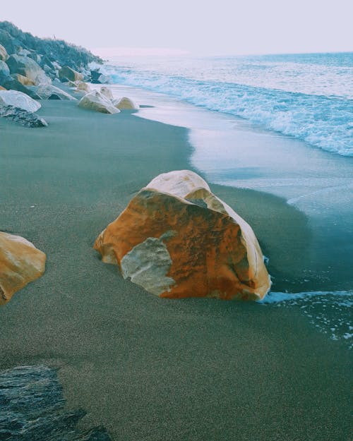 Photography of Brown Rock Near Sea