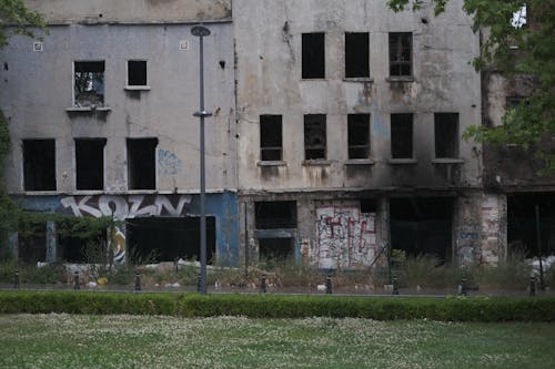 A man is walking through an abandoned building