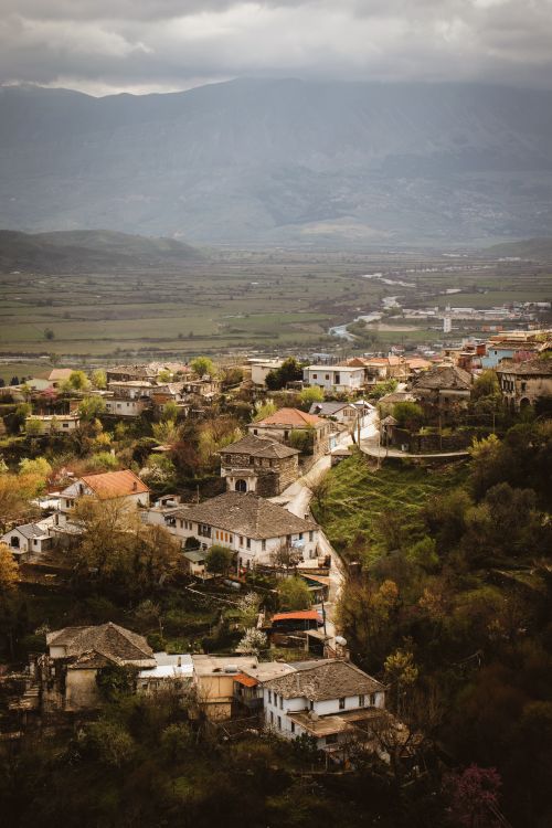 Free Aerial view of historic Gjirokaster in Albania with traditional houses and mountainous backdrop. Stock Photo