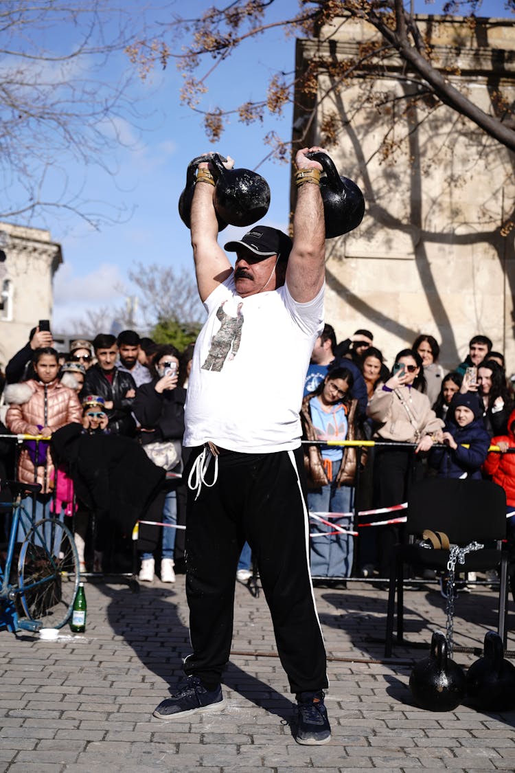 Man Holding Weights On A Square 