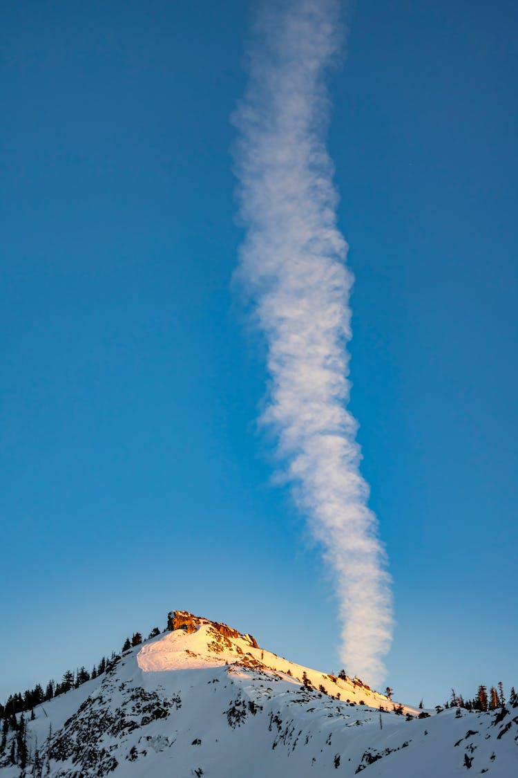 Smoke Over Hill In Winter