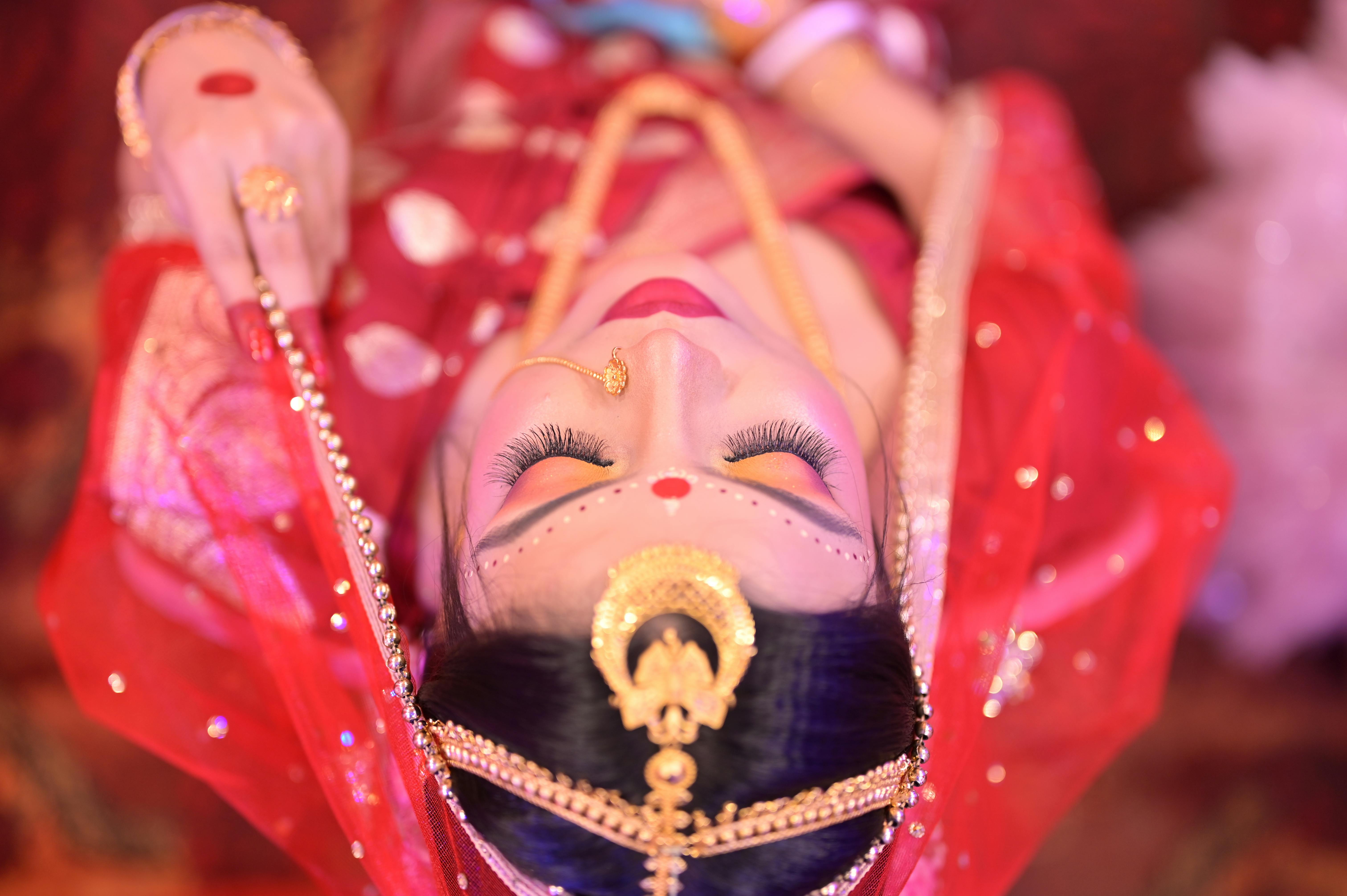 Captivating top view of an Indian bride adorned in traditional outfit and gold jewelry, showcasing cultural elegance.