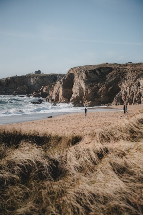 A couple walking along the beach near the ocean