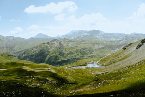 Free A view of a valley with mountains and grass Stock Photo