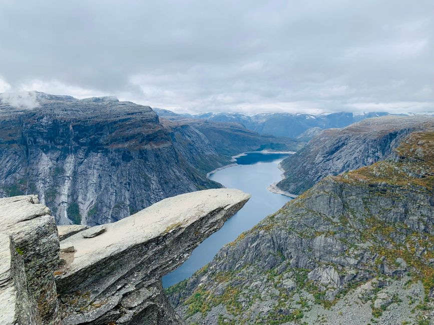 Best Bergen: Private Full-Day Waterfall Day to Hardangerfjord & Cruise Review Review 2026 - Breathtaking aerial view of the iconic Trolltunga rock formation overlooking a serene lake in Ullensvang, Norway.