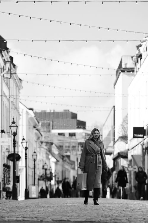 Free A black and white street photo capturing a woman walking in Jönköping, Sweden. Stock Photo