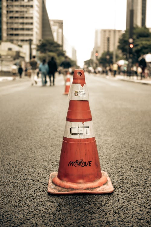 A traffic cone on the street with the word ted on it