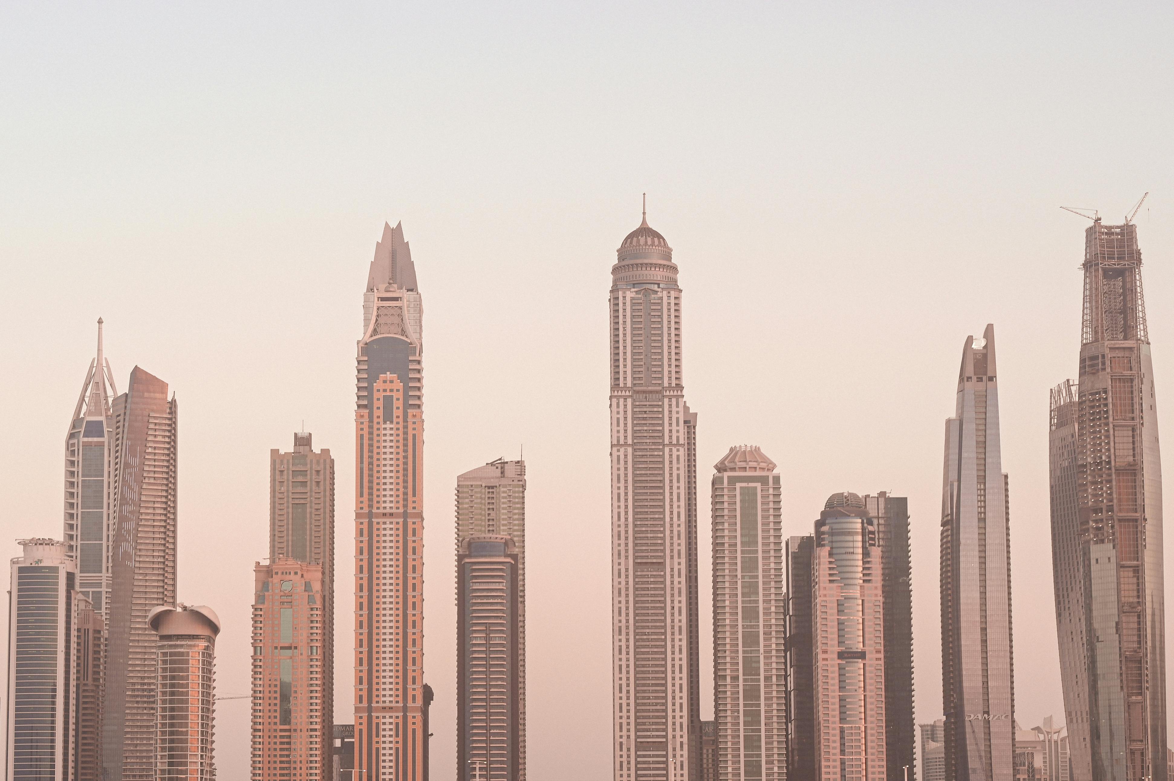 futuristic city skyline with digital tokens floating above buildings, symbolizing tokenized real estate