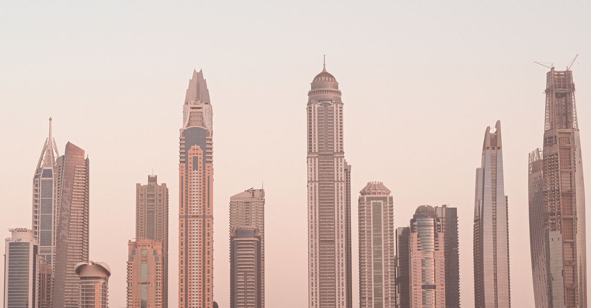futuristic city skyline with digital tokens floating above buildings, symbolizing tokenized real estate