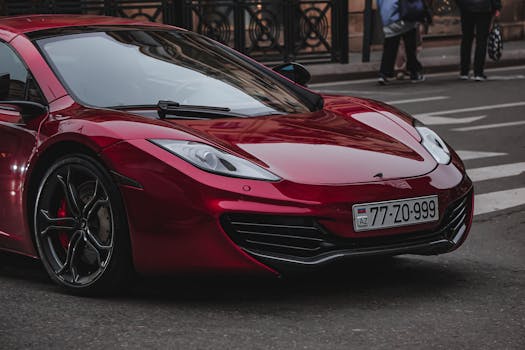 A luxurious red sports car parked on a city street, showcasing its sleek design and modern aesthetics.