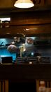A chef prepares ramen in a Tokyo restaurant kitchen, capturing the culinary art scene.