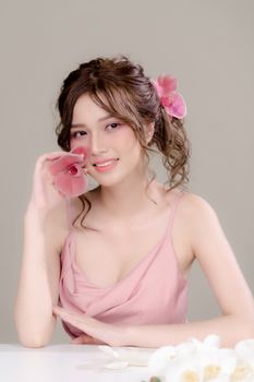 A serene portrait of a woman smiling, with flowers in her hair, exuding elegance and beauty.