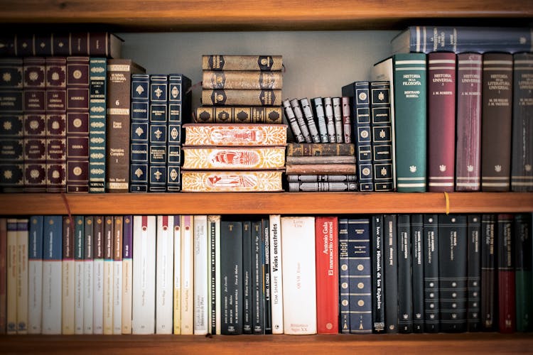 Assorted Books On Book Shelves