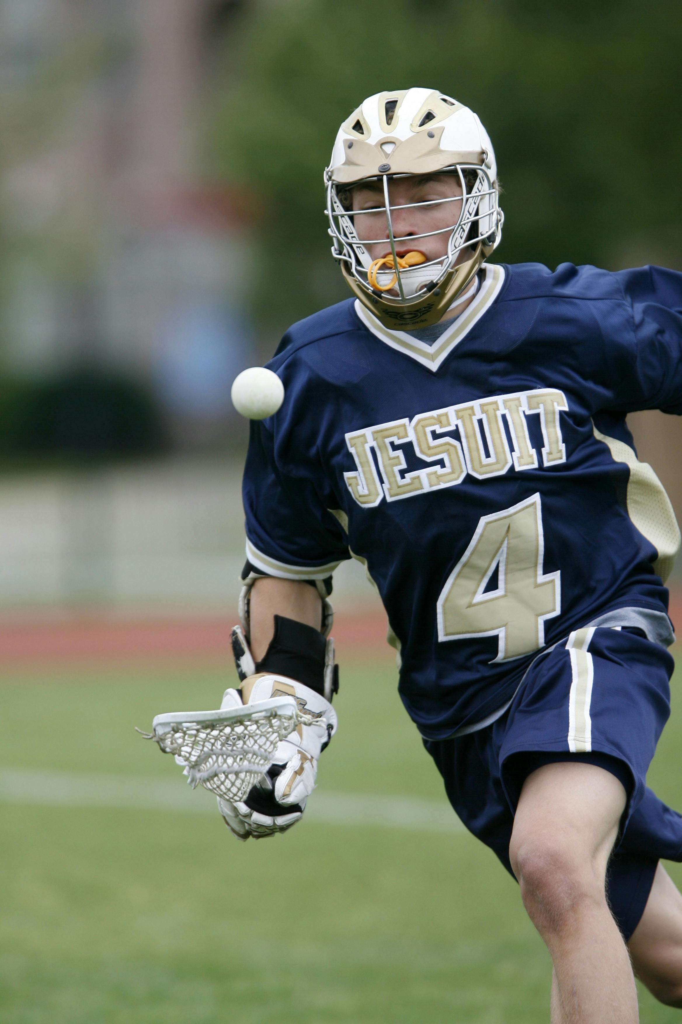 Man Holding Lacrosse Stick Running On Field During Daytime Free Images, Photos, Reviews