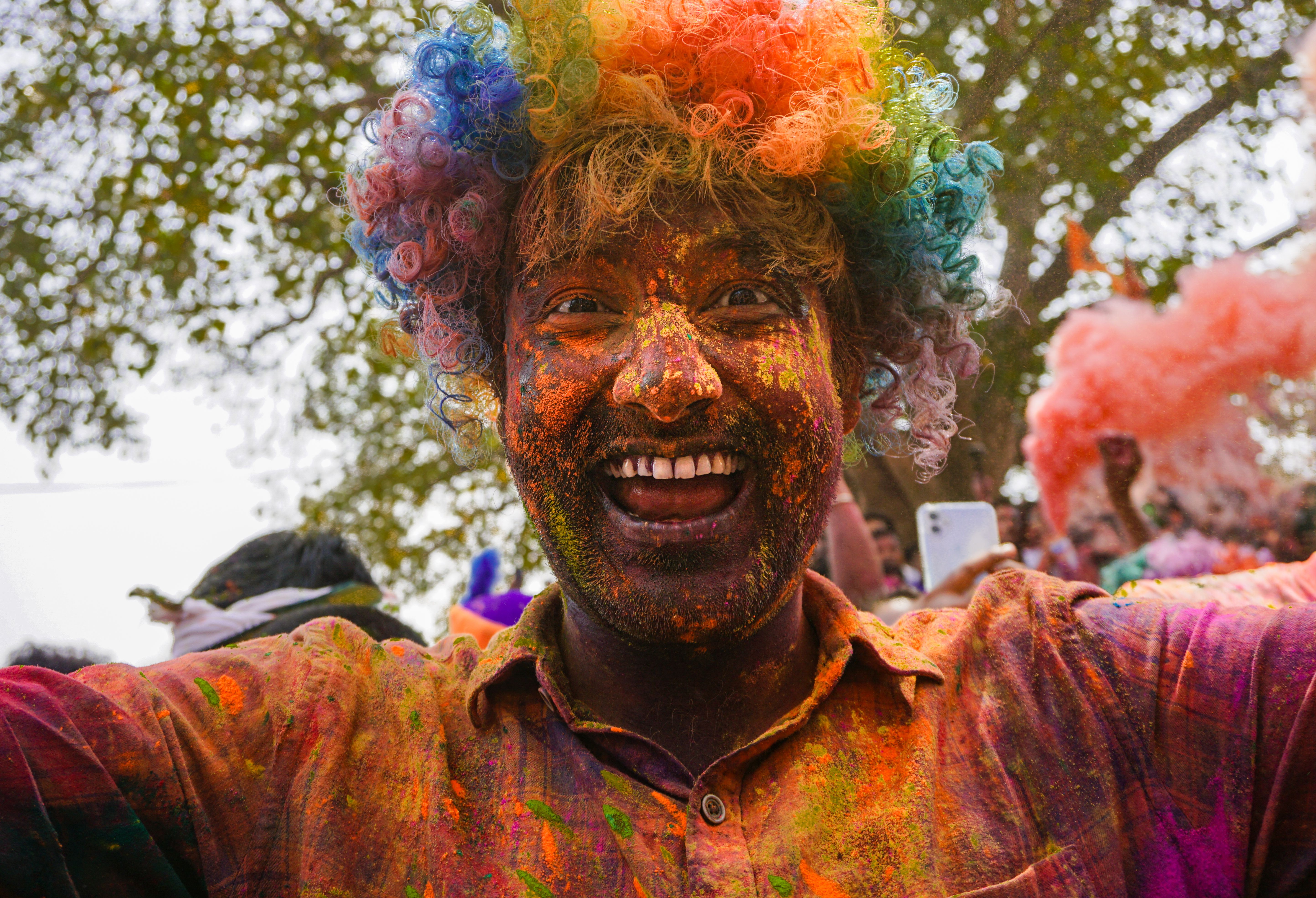 Colorful Powder on Smiling Man Face in Festival · Free Stock Photo