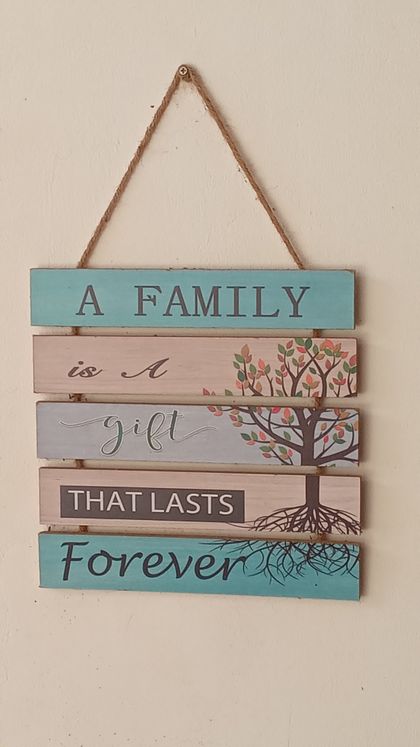 Hand-painted slatted wooden wall sign hung on twine — photo by Rolando Pesarit on Pexels
