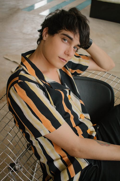 Man Wearing Orange, Beige, and Black Striped Button-up Shirt