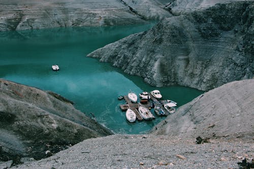 Boats in Body of Water Near the Mountain