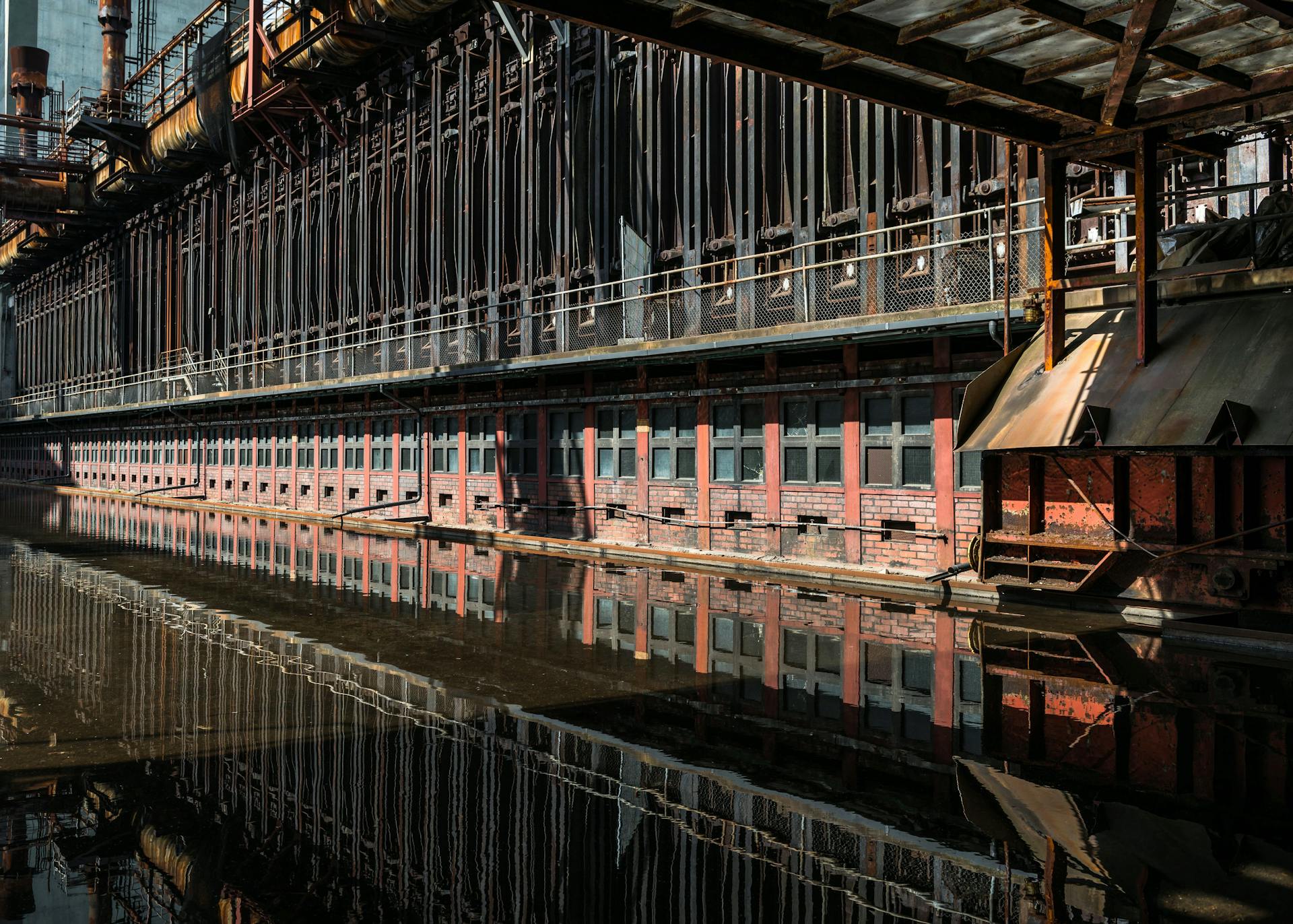 Reflection of the historic Zollverein Coal Mine Industrial Complex in Essen, Germany, showcasing industrial architecture.