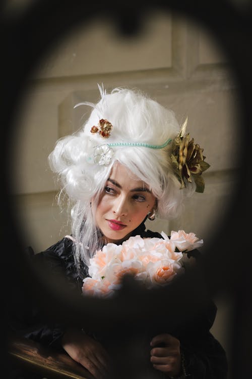 A woman with white hair and flowers in her hair