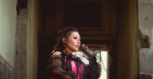 A woman in a pink dress talking on a cell phone