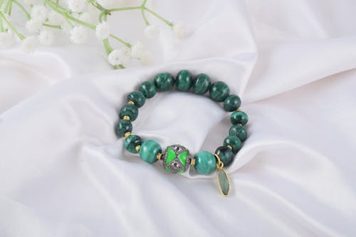 Green jade bracelet with gold and green beads