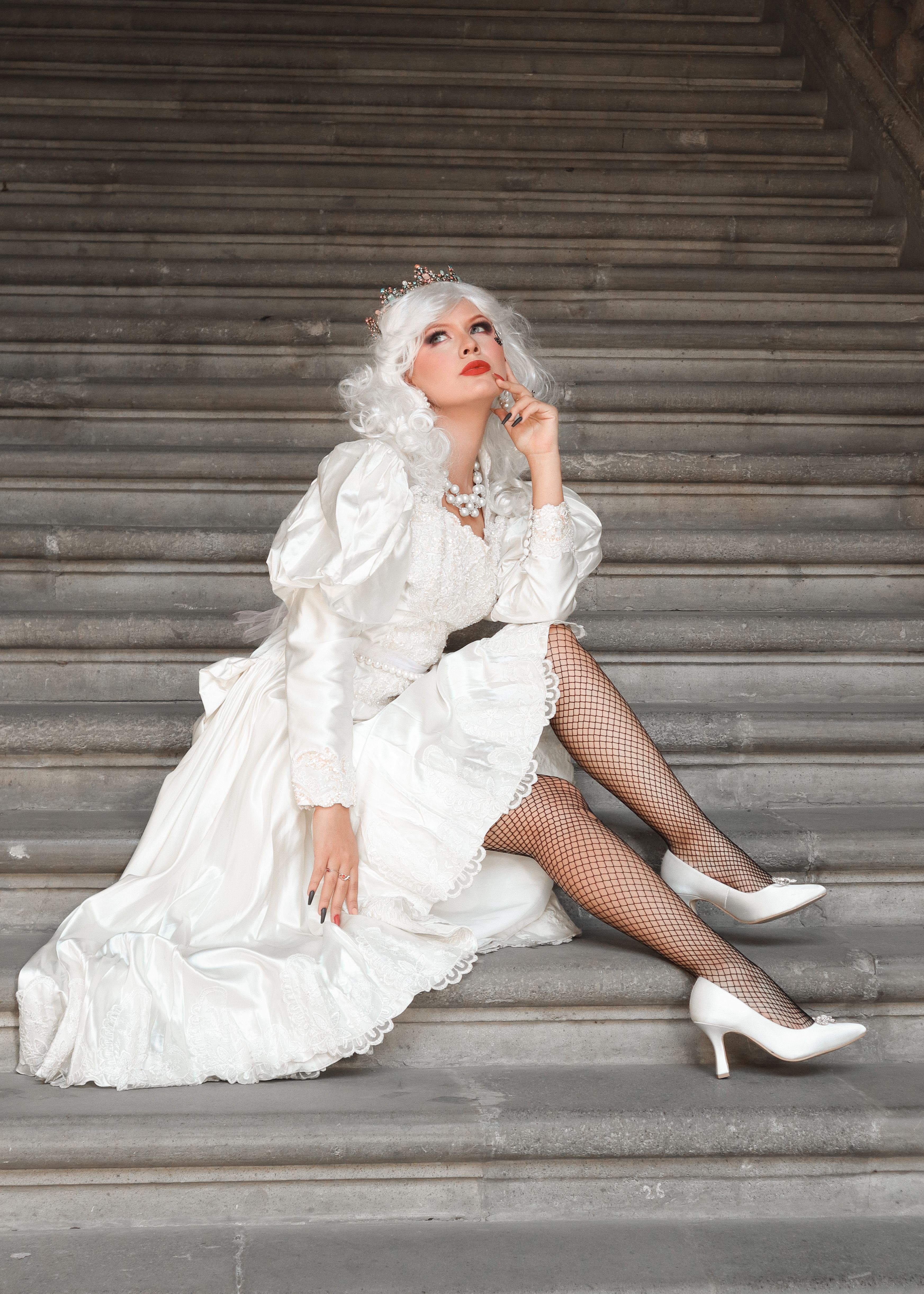 Woman in Crown and White Dress Sitting on Stairs · Free Stock Photo