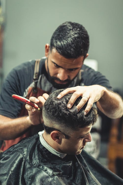 Barber Cutting Person's Hair
