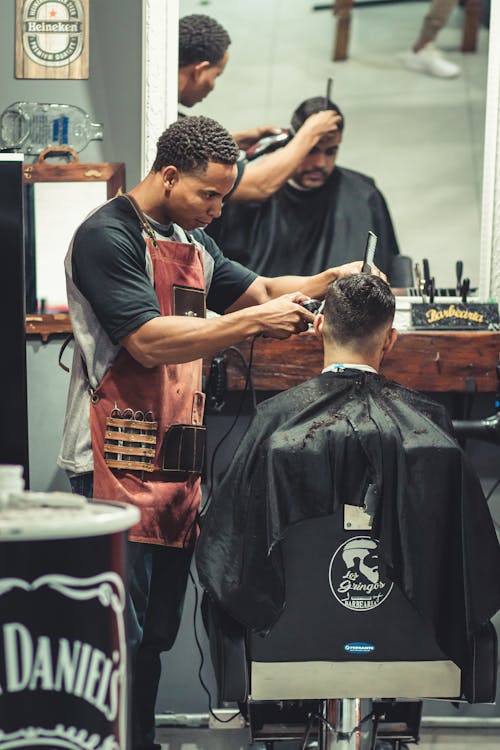 Person Cutting Hair of Man