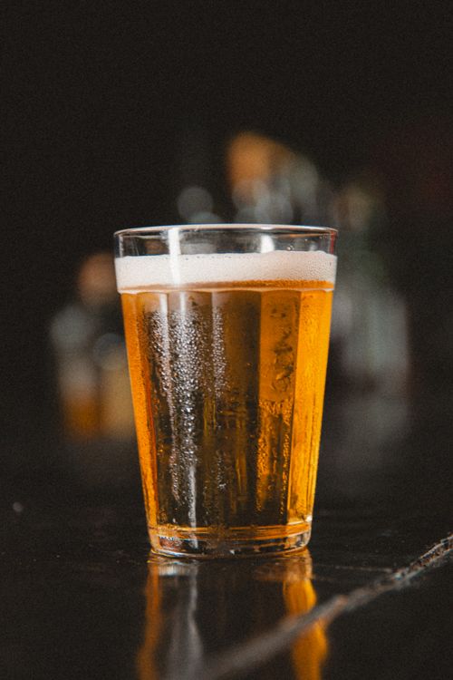 Free A refreshing glass of beer with bubbles and foam, perfect for a cold drink concept. Stock Photo