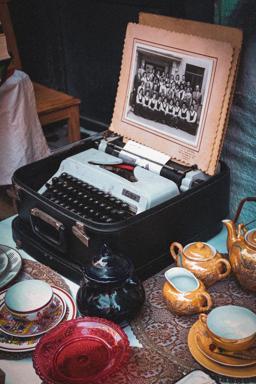 Free Charming display of a vintage typewriter and porcelain tea set with antique decor. Stock Photo