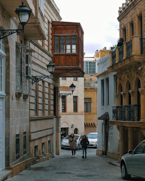 A person walking down a narrow street in malta