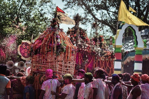 A group of people standing around a decorated float