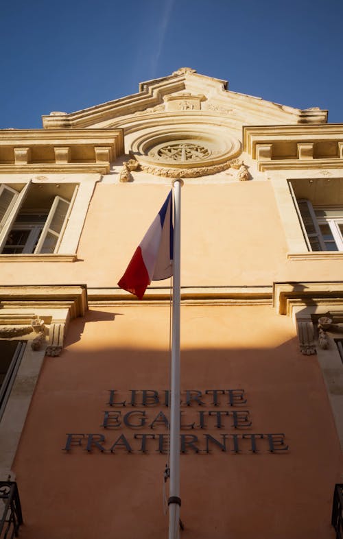 The french flag flies outside a building