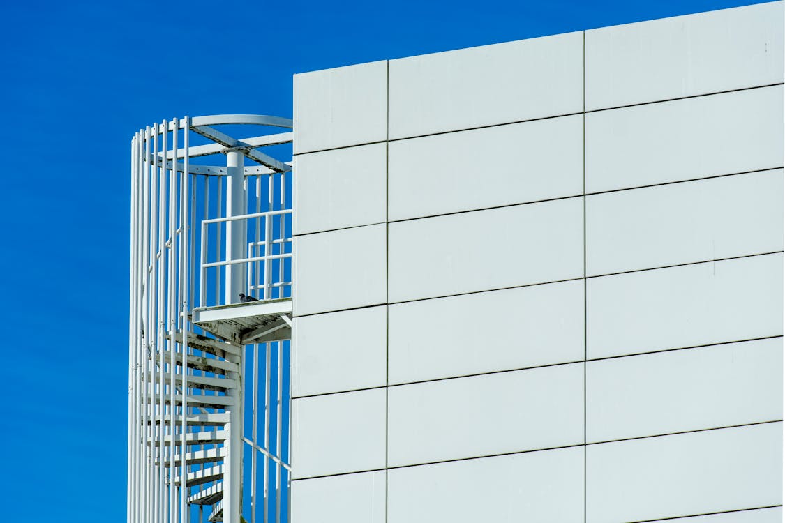 A spiral staircase is on the side of a building