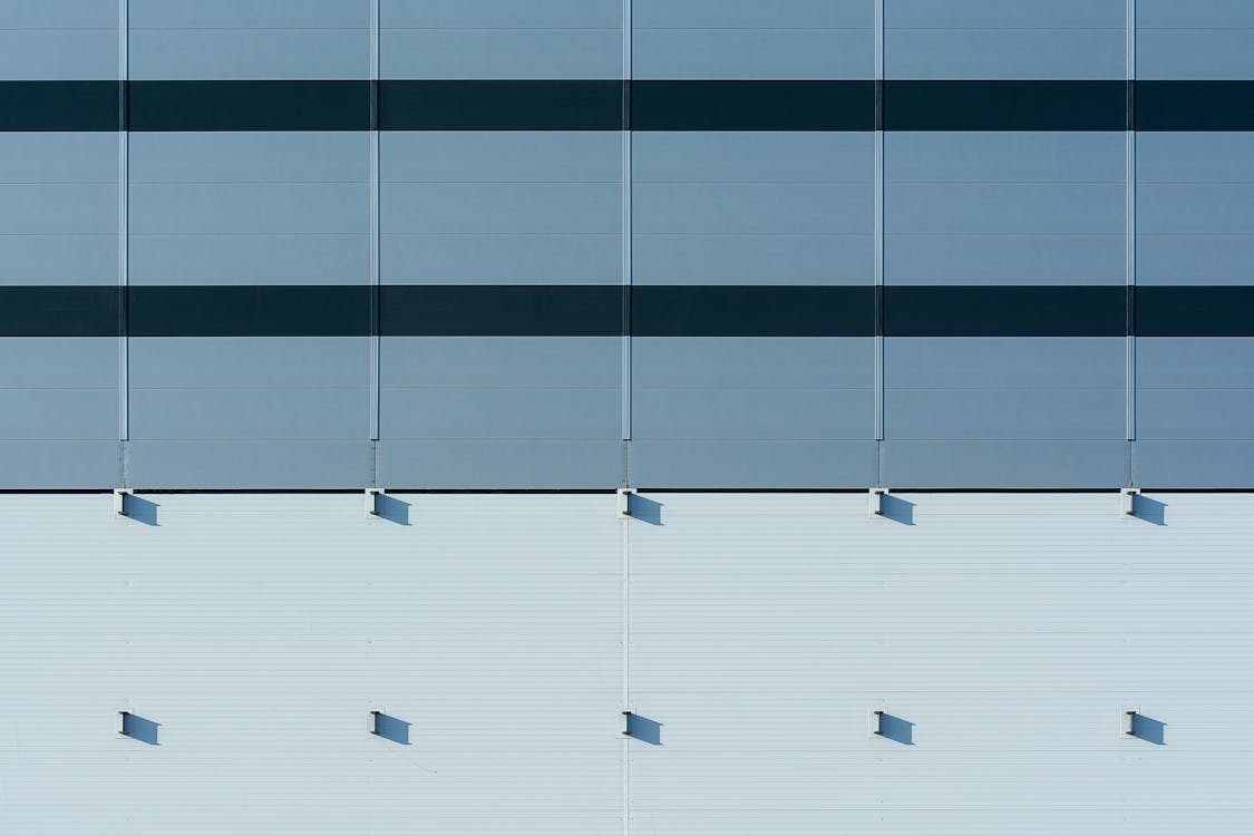 A close up of a building with blue and white stripes
