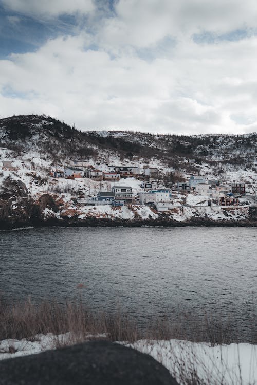 A snowy landscape with a small town in the background