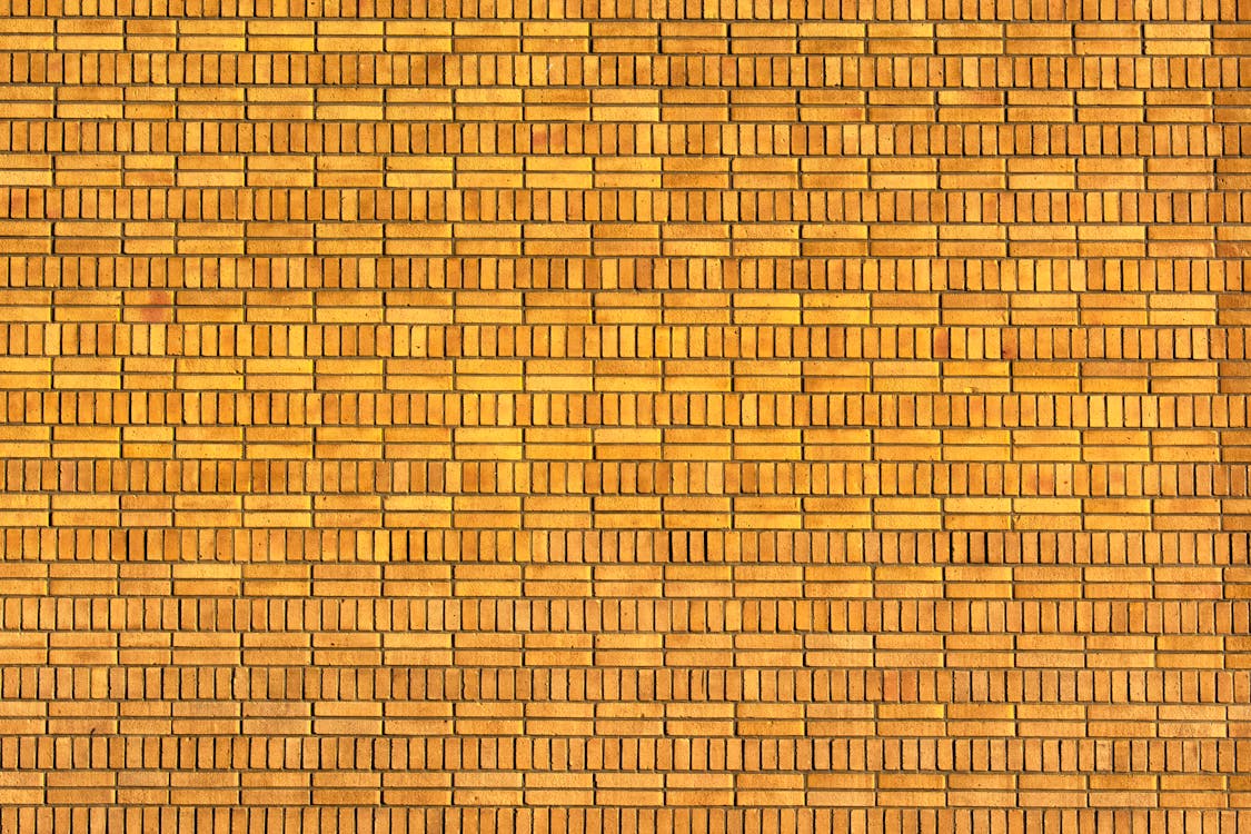 A brick wall with a pattern of bricks