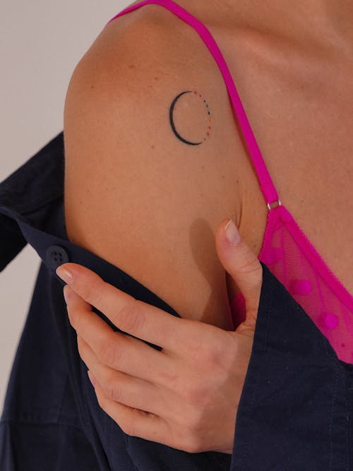 A woman with a crescent tattoo on her arm