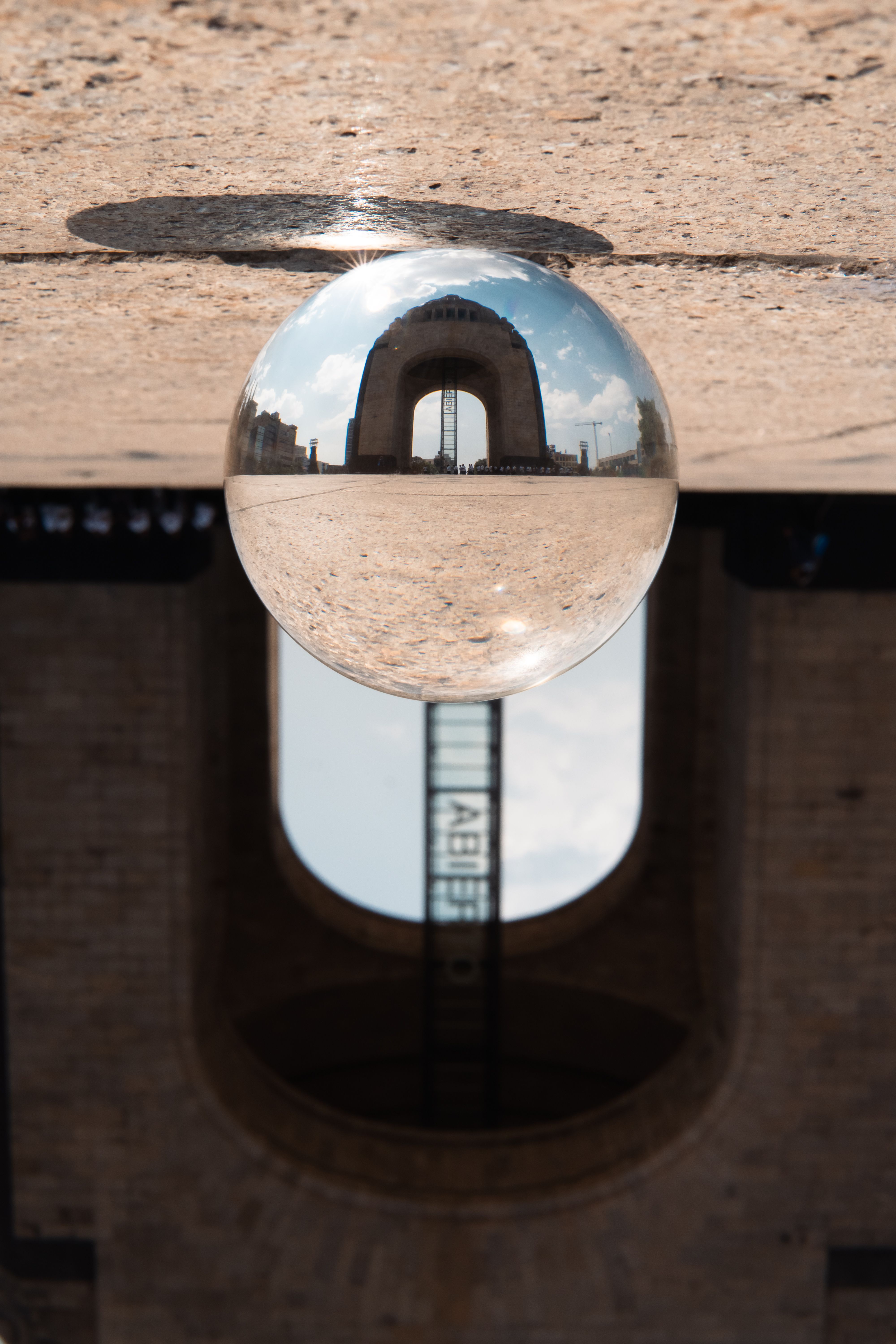 A reflection of a building in a glass ball · Free Stock Photo