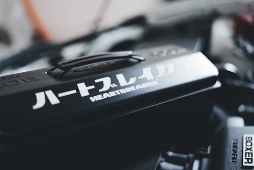 A close up of a car engine with a japanese writing on it