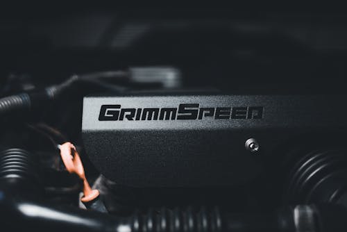 A close up of the engine of a car with the word grimm speed